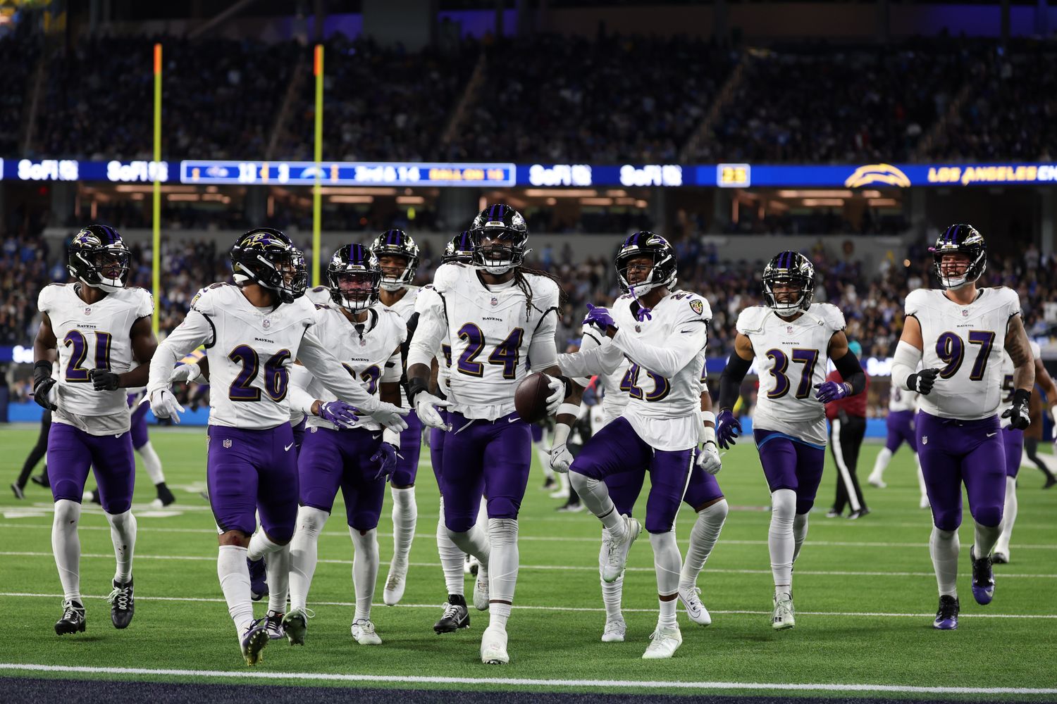 Baltimore Ravens linebacker Jadeveon Clowney (24) celebrates with his teammates after recovering a fumble against the Los Angeles Chargers during the fourth quarter at SoFi Stadium. Mandatory Credit: Kiyoshi Mio-USA TODAY Sports